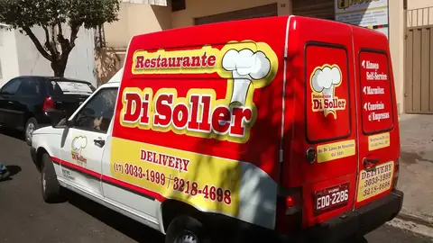 Furgão vermelho e branco com adesivagem do Restaurante Di Soller e telefones de delivery