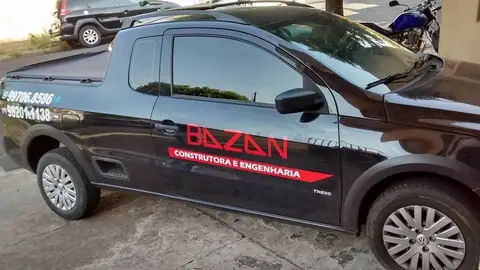 Picape preta com adesivo vermelho e branco Bazan Construtora e Engenharia na porta