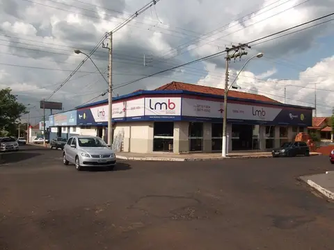 Fachada longa de esquina com faixas azuis e brancas da lmb sob telhado colonial